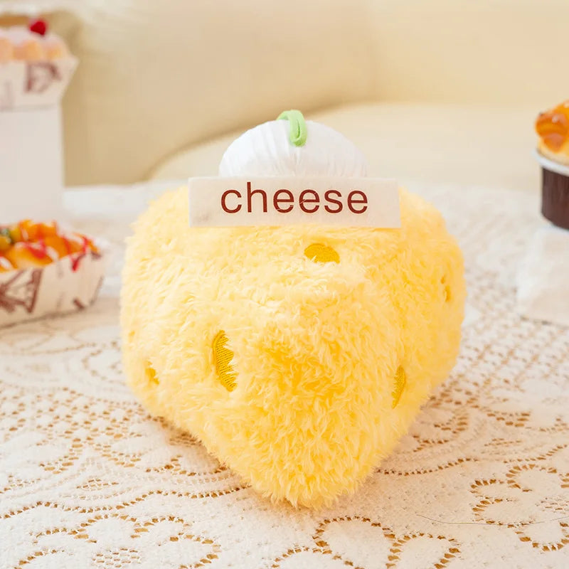 Plush toy shaped like a cheese block with a 'cheese' label on a lace tablecloth.