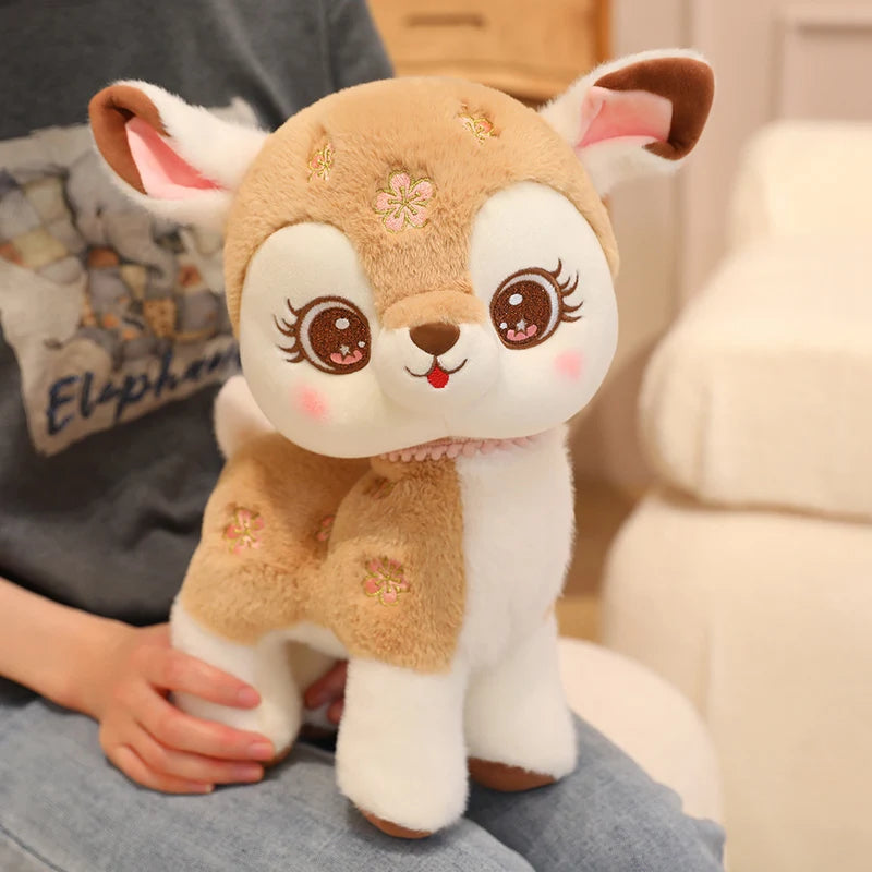 Plush toy deer held by a person with a blurred background