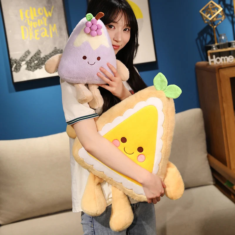 Person holding two plush toys shaped like cake and pie in a living room setting.