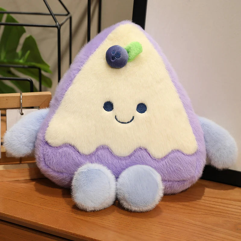 Plush toy shaped like a cake slice with a purple border on a wooden surface.
