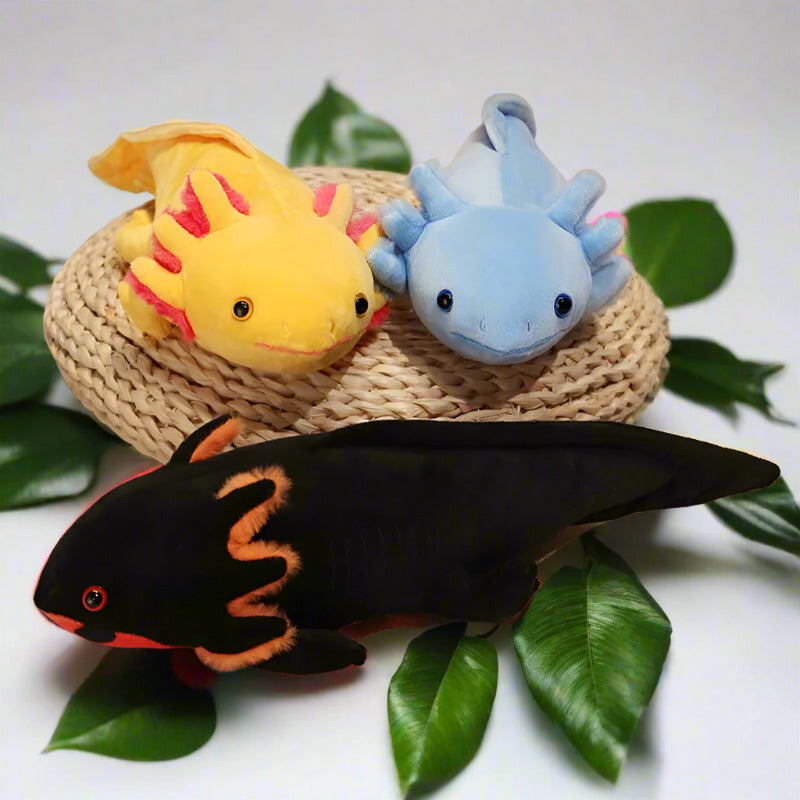Three salmander stuffed animals that are yellow, blue, and black