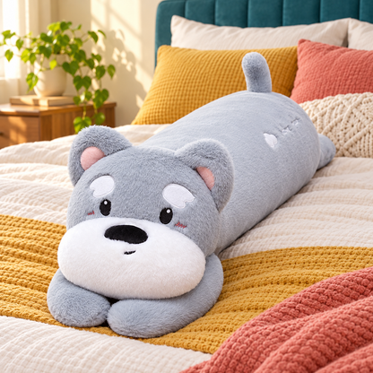 Silver gray long puppy plush body pillow with a white muzzle, gray paws, eyebrow patches, and upright tail displayed on a mustard and coral bed.