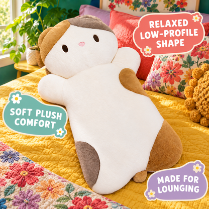 Calico lying cat plush pillow highlighting its low-profile shape and soft comfort.