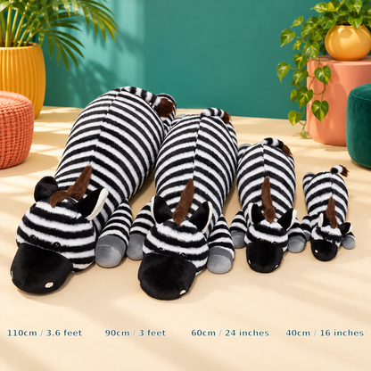 Four black-and-white zebra plush body pillows arranged by size from 110cm / 3.6 feet to 40cm / 16 inches in a colorful teal, mustard and coral studio.