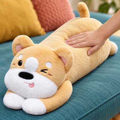 Adult hand gently pressing the honey gold Puppy Hugs plush body pillow to show its soft velvety texture and lightly stuffed body.