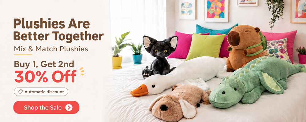 Promotional banner for a plushies mix-and-match set, showing several stuffed toys including a black cat plush, white duck, green alligator, brown bear, and beige dog on a bed with colorful pillows, alongside text reading 'Plushies Are Better Together' and 'Buy 1, Get 2nd 30% off'.