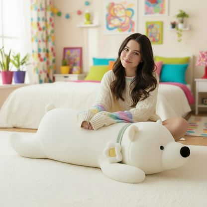 Woman sitting on a large white bear-shaped plush body pillow in a colorful room.