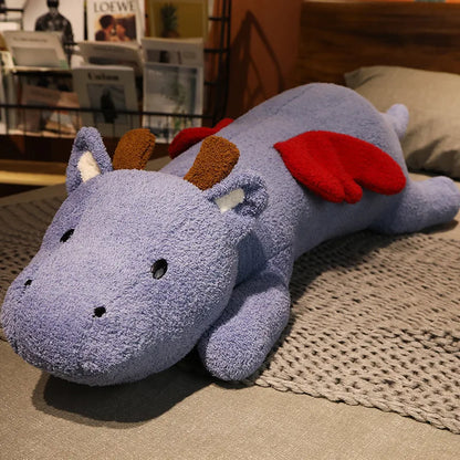 Plush dragon toy on a textured surface with a blurred indoor background