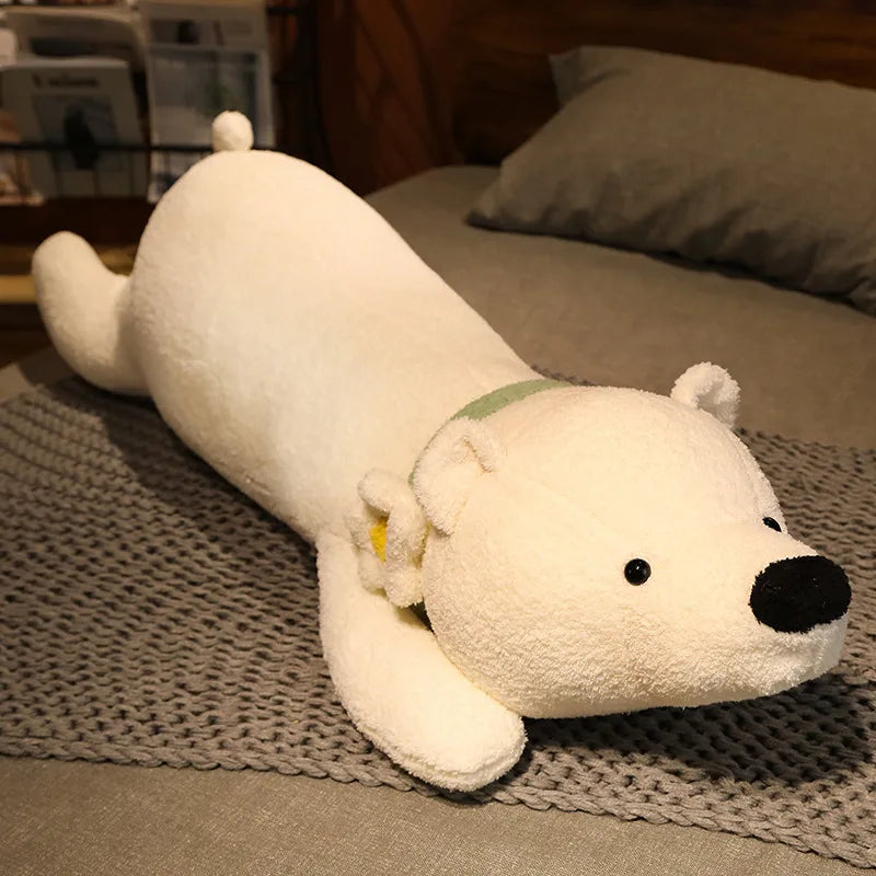 White plush toy resembling a polar bear lying on a textured surface.