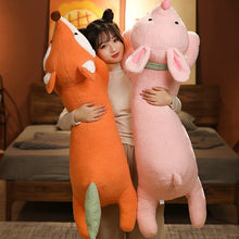 Person holding an orange fox plush toy and a pink elephant plush toy in a room.