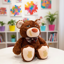 Plush teddy bear with a bow tie sitting on a table in a room with colorful abstract art and plants.