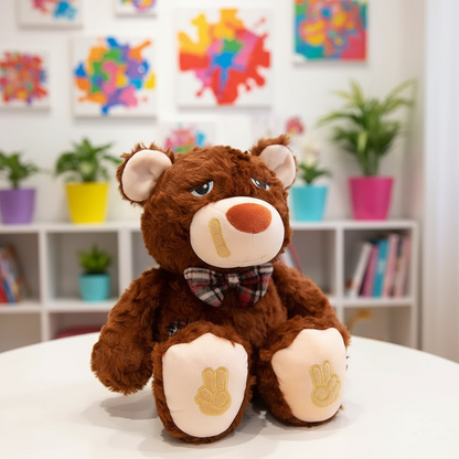 Plush teddy bear with a bow tie sitting on a table in a room with colorful abstract art and plants.