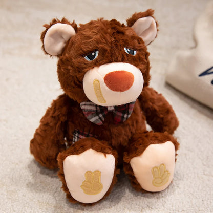 Brown teddy bear with a bow tie and bandaid on a light surface
