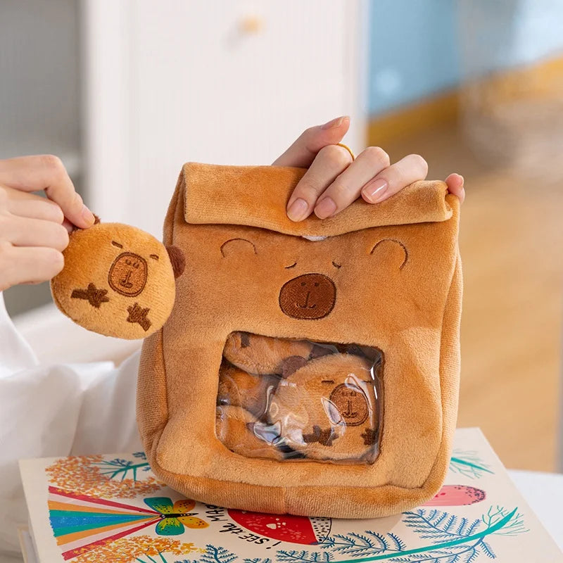 Capybara-shaped plushie bag held by a person with a colorful background