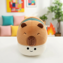 Plush toy with a capybara design on a white surface with a colorful background