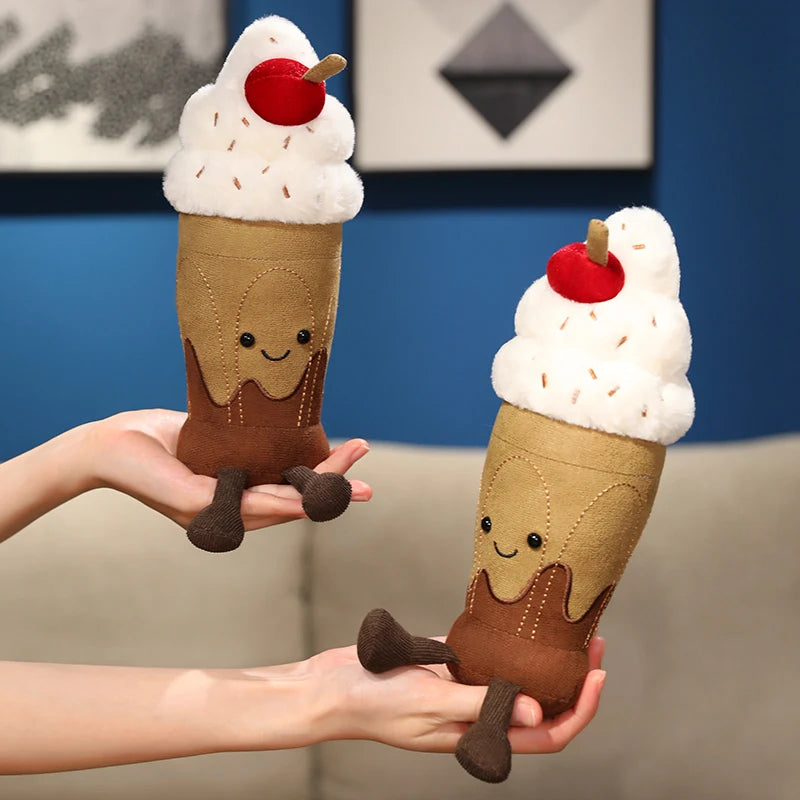 Two plush ice cream cone toys held by a person against a blue wall.