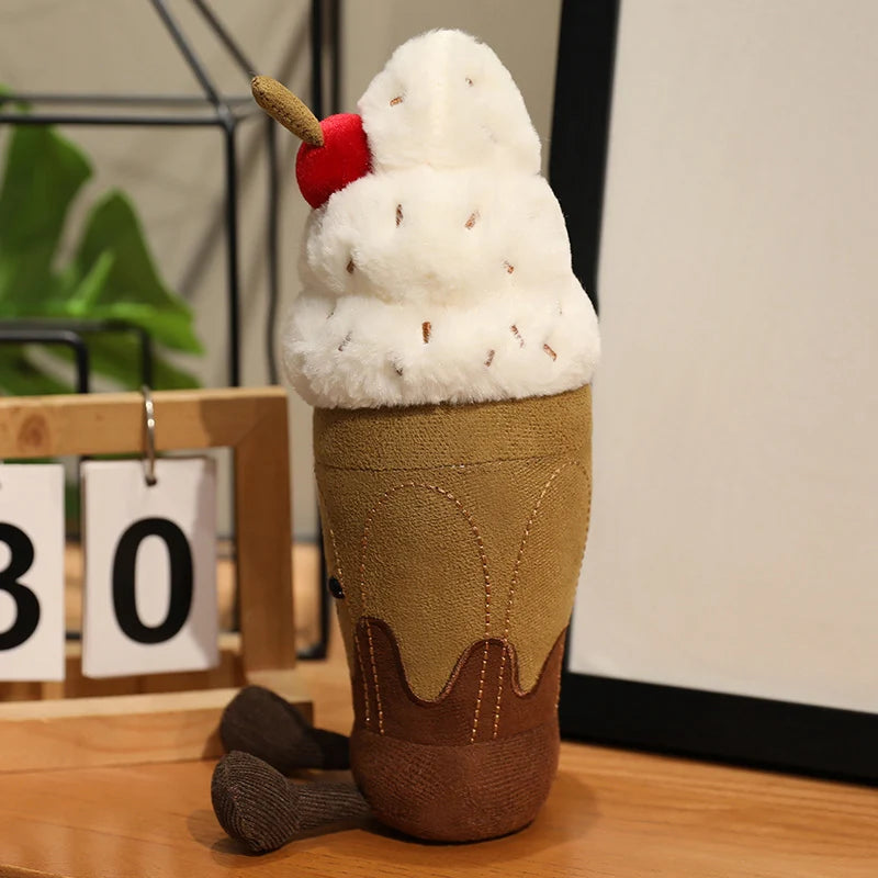 Plush toy resembling an ice cream cone with a cherry on top on a wooden surface.