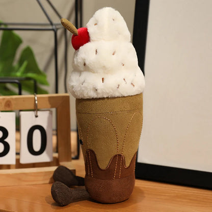 Plush toy resembling an ice cream cone with a cherry on top on a wooden surface.