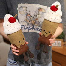 Two plush ice cream cone toys held by a person wearing a shirt with an elephant design.