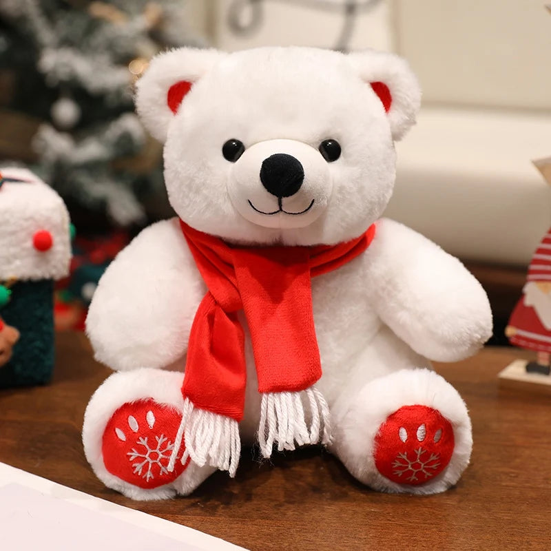 White teddy bear with a red scarf on a wooden surface with a blurred Christmas tree in the background.