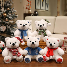 White teddy bears with scarves in front of a decorated Christmas tree and couch.