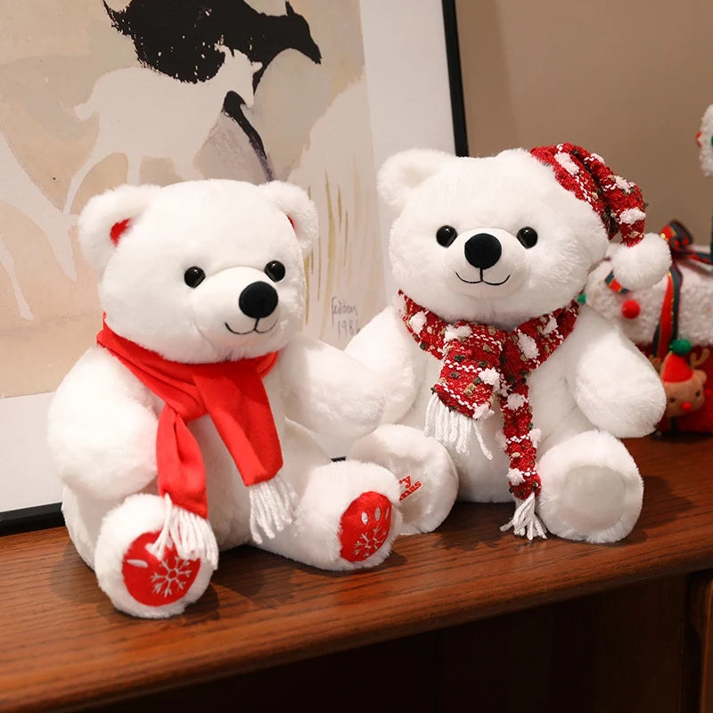 Two white teddy bears with red scarves on a wooden surface.