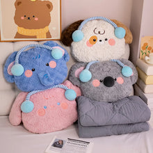 Four plush toys shaped like animals with colorful ears and faces on a bed.