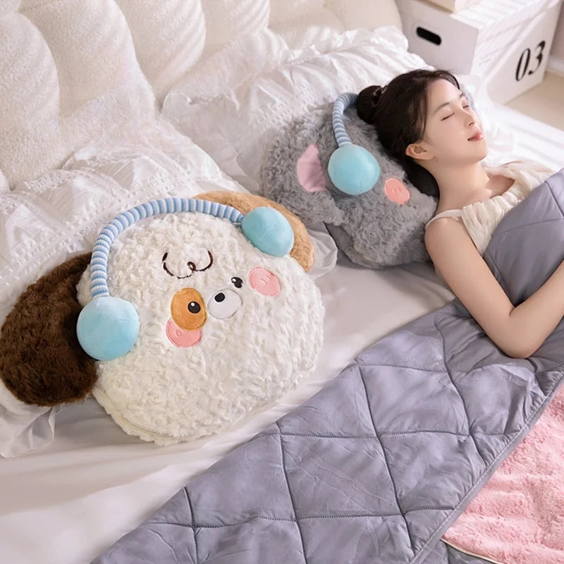 Person lying on a bed with plush toys and a blanket