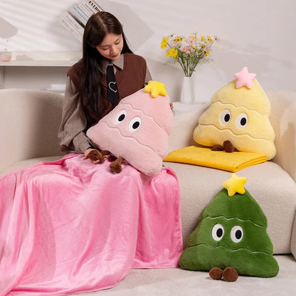 Person sitting on a couch with plush toys shaped like Christmas trees in various colors.