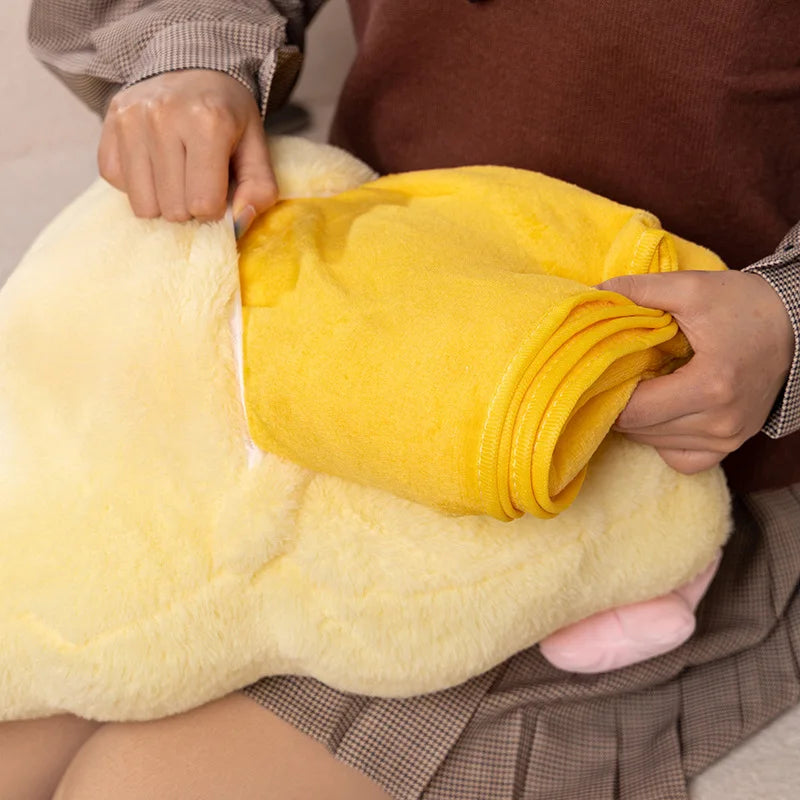 Person holding a yellow plushie and blanket with soft texture