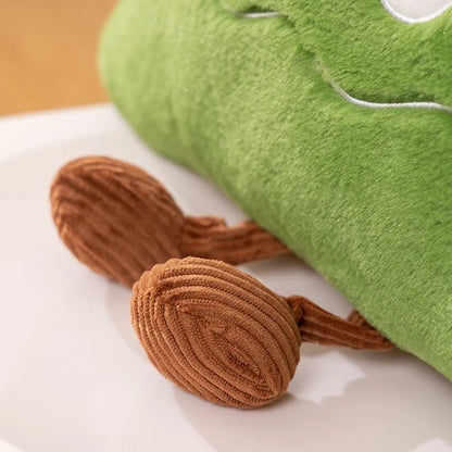 Green plush toy with brown accents on a white surface