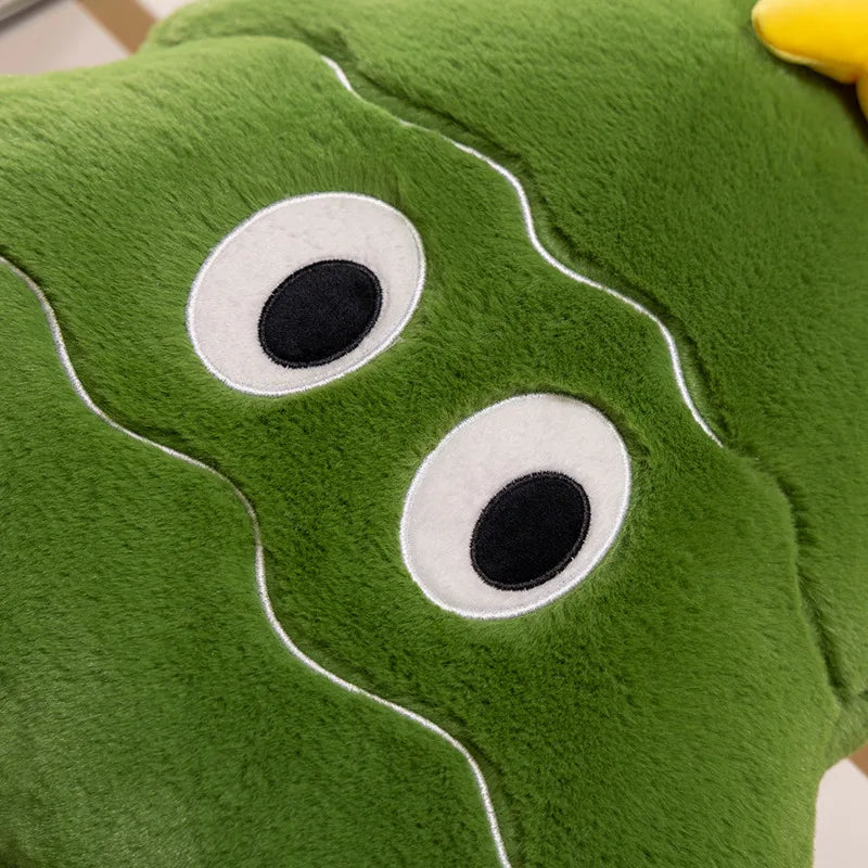 Close-up of a green plush toy with googly eyes