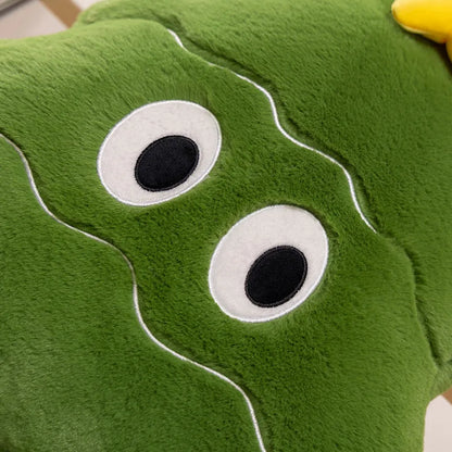 Close-up of a green plush toy with googly eyes