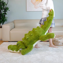 Person holding a large green plush crocodile in a living room.