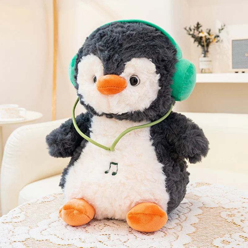 Plush penguin toy with green headphones on a lace tablecloth