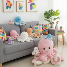 Colorful plush octopus toys on a gray sofa in a bright living room.