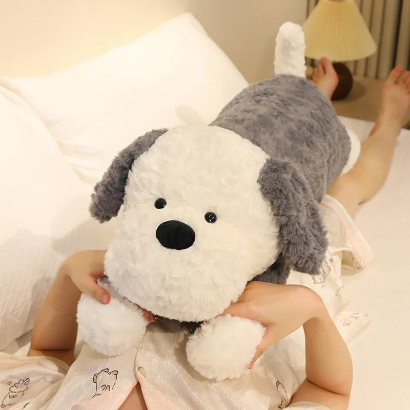 Person holding a large plush dog toy in a bedroom setting