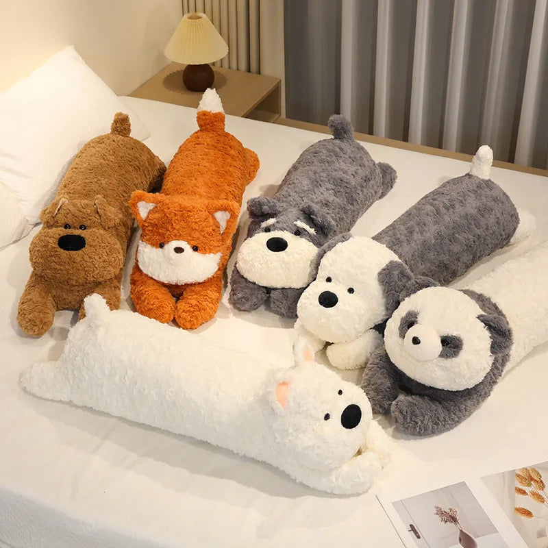 Set of plush animal-shaped pillows on a bed