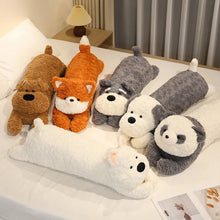 Set of plush animal-shaped pillows on a bed
