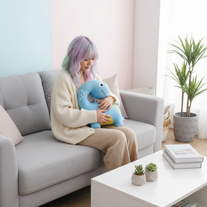 Person sitting on a couch holding a blue plush toy in a modern living room.