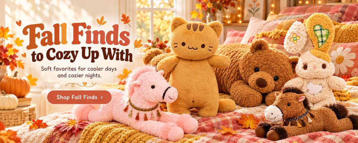 Dandelion Vine Fall Finds plushie collection in a cozy autumn bedroom, featuring Marmalade Tabby Cat, Bearly Awake Teddy Bear, Heartstitched Bunny, and Meadow Mane Horse body pillows surrounded by warm blankets, pumpkins, and fall leaves.