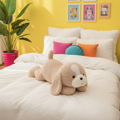 A beige plush dog body pillow with a white snout and ears lies on a white bed in a bright bedroom with a yellow wall, colorful pillows, framed art, and a potted plant.