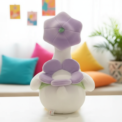 Plush toy duck with a flower of a purple petal on a blurred indoor background