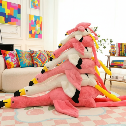 Stack of pink flamingo plush toys in a living room setting with colorful cushions and books.