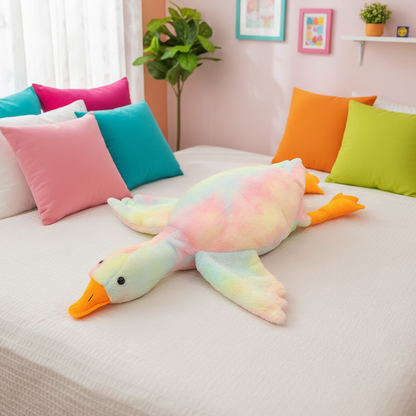 Colorful plush goose toy on a bed with multicolored pillows and a plant in the background.