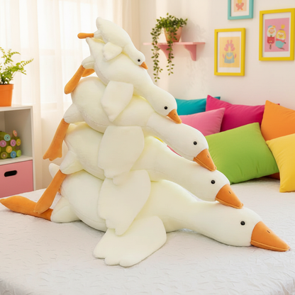 Stack of plush ducks or geese on a bed with colorful pillows and decor in the background