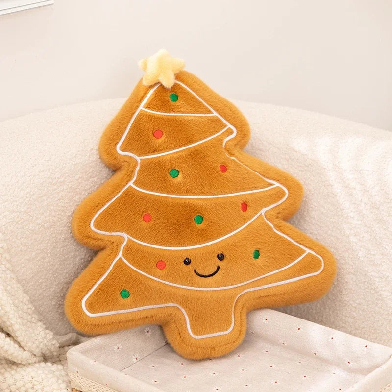 Plush toy shaped like a gingerbread cookie Christmas tree with a smiley face on a soft surface