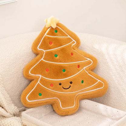 Plush toy shaped like a gingerbread cookie Christmas tree with a smiley face on a soft surface