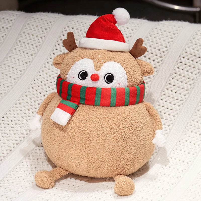 Plush toy reindeer wearing a Santa hat and scarf on a textured white surface