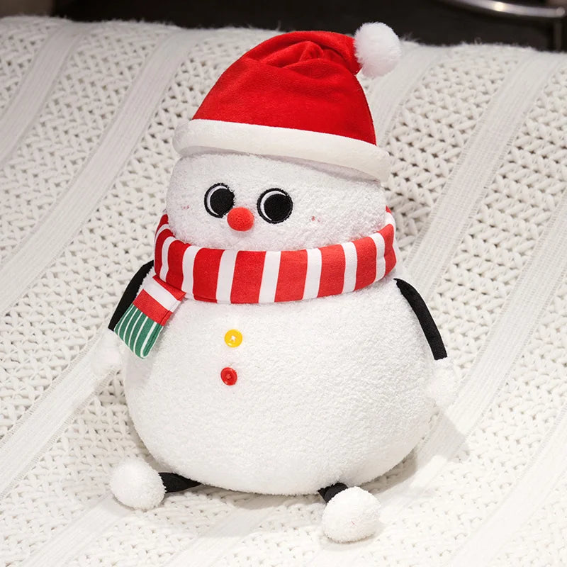 Plush snowman toy with a red hat and scarf on a textured white background